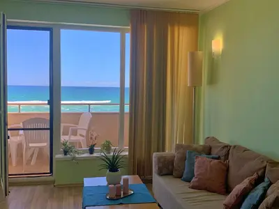 a living room with a couch and a view of the ocean at Apartments Obzor Beach B - Апартаменти Обзор Бийч B in Obzor