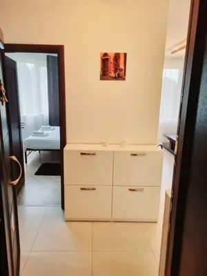 a room with a white dresser and a bedroom at Apartament BEACH VIBES Nessebar in Nesebar
