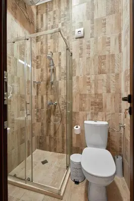 a bathroom with a toilet and a glass shower at Studio in Sarafovo with Private Parking Spot by Flat Mаnаger in Burgas City