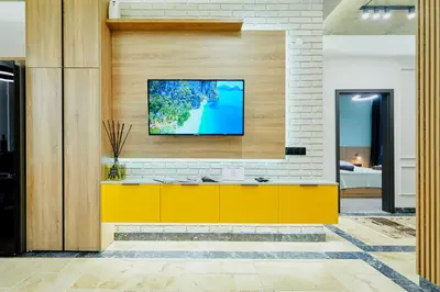 a living room with a tv on a brick wall at Florance Rentals Luxury Apartments in Burgas in Burgas City