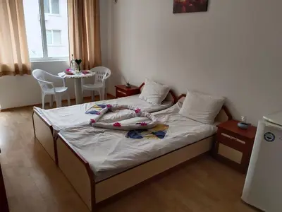 a bedroom with a bed with two dolls on it at Стаи за гости Ники in Nesebar