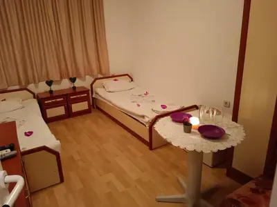 a small room with a bed and a table at Стаи за гости Ники in Nesebar