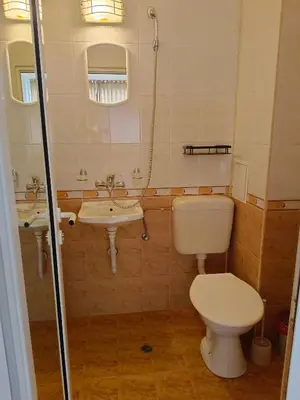 a bathroom with a toilet and a sink at Стаи за гости Ники in Nesebar