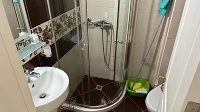 a bathroom with a shower and a sink at Stamopolulux директен изглед към морето in Primorsko