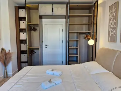a bedroom with a bed with two towels on it at Apartment Marbél - Designer Retreat with FREE parking in Burgas City