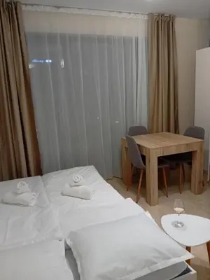 a hotel room with two beds and a table at Sveti Vlas Sea Dreams apartament in Sveti Vlas