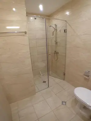 a shower with a glass door in a bathroom at Sveti Vlas Sea Dreams apartament in Sveti Vlas
