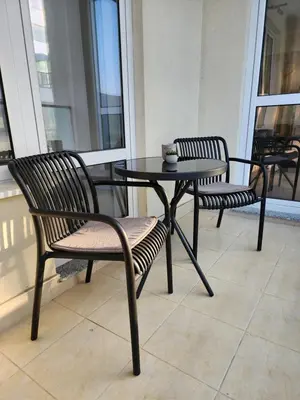 two chairs and a table on a balcony at Central Park Galleria in Burgas City