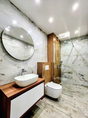 a bathroom with a sink and a toilet and a mirror at Central Park Galleria in Burgas City