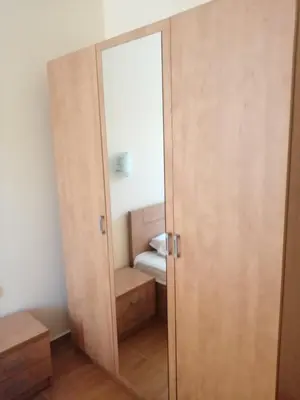 an open door to a bedroom with a mirror at Panorama Dreams - Sveti Vlas - Furnished Apartment with a Terrace and a Sea View in Sveti Vlas