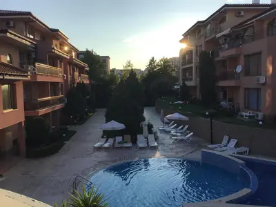an outdoor swimming pool in a courtyard of a building at Panorama Dreams - Sveti Vlas - Furnished Apartment with a Terrace and a Sea View in Sveti Vlas