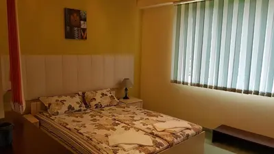 a bed in a room with a window and a bed sidx sidx sidx at Aheloy Apartments in Aheloy