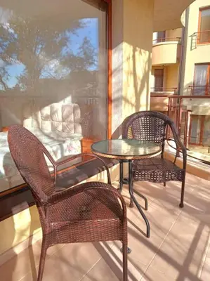 a patio with two chairs and a glass table and chairs at Three-room apartment in Sveti Vlas