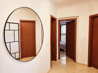 a round mirror on a wall in a room at Three-room apartment in Sveti Vlas