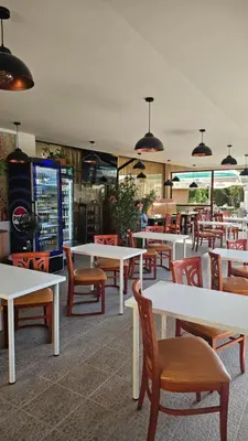 a restaurant with white tables and chairs and tables at Three-room apartment in Sveti Vlas