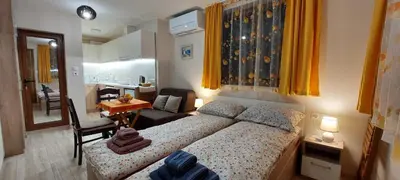 a small bedroom with a bed and a kitchen at Studio GALILEO in Burgas City