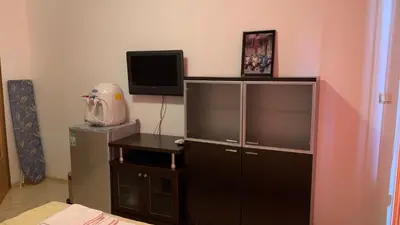 a bedroom with a tv and a dresser with a tvictericter at Stamopolu Parter in Primorsko