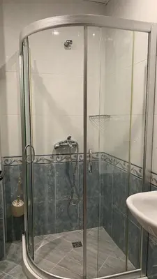 a glass shower in a bathroom with a sink at Stamopolu Parter in Primorsko