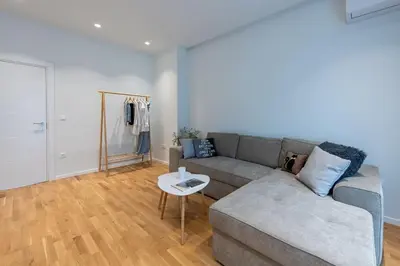 a living room with a couch and a table at Modern & Stylish Sea Apartment with Parking in Burgas City