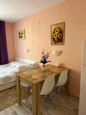 a dining room with a table with chairs and a bed at Studio Sveti Vlas SEA BREEZE 3 in Sveti Vlas