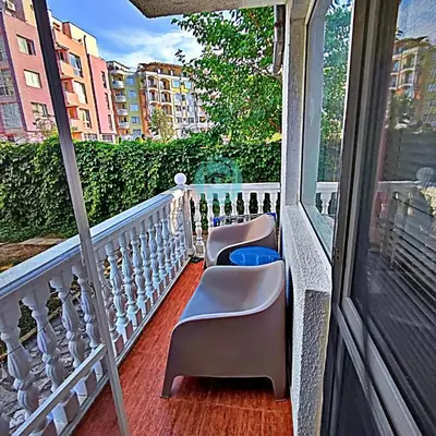 a balcony with two chairs and a window at BRAVO 5 - Sunny Beach Center in Sunny Beach