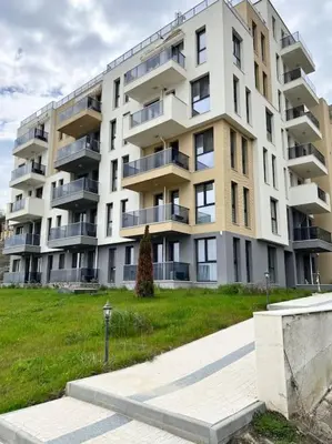 a large apartment building with a lawn in front of it at Marino Liberta South Beach Obzor in Obzor