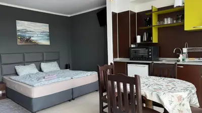 a small bedroom with a bed and a kitchen at Top Studio in Big Kamelia Holiday Complex Sunny Beach in Sunny Beach