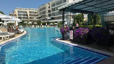 a swimming pool with blue water in a hotel at Top Studio in Big Kamelia Holiday Complex Sunny Beach in Sunny Beach