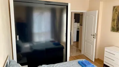 a glass door in a room with a bedroom at 2 Room Apartment in Luxury Complex Sunny Beach in Sunny Beach