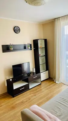 a living room with a flat screen tv and a entertainment center at 2 Room Apartment in Luxury Complex Sunny Beach in Sunny Beach