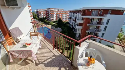 a balcony with a table and a dog toy on a table at Studio Robinson Beach Sea Nessebar View in Sveti Vlas