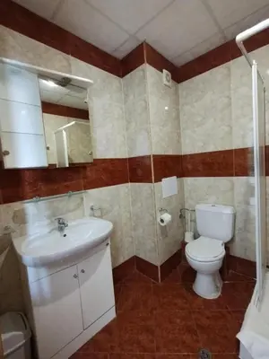 a bathroom with a toilet and a sink at Studio Robinson Beach Sea Nessebar View in Sveti Vlas