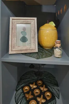 a shelf with a picture and some donuts and a vase at Batak Studio in Burgas City