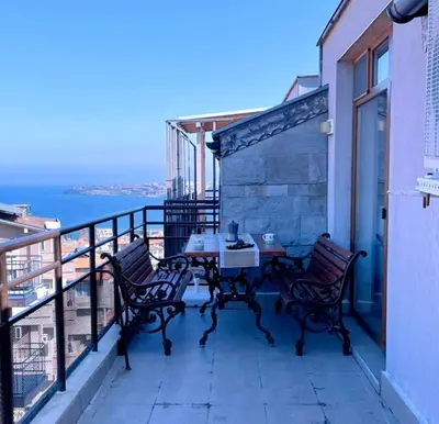 a patio with a table and chairs on a balcony at Модерен апартамент в сърцето на Созопол in Sozopol