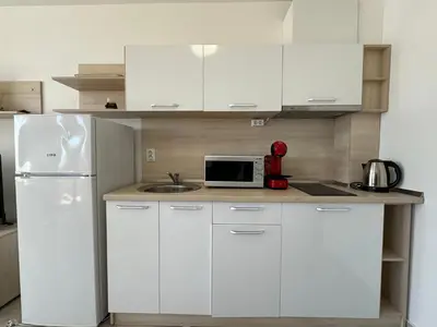 a kitchen with white cabinets and a white refrigerator at HORIZON Apartment 8,1 'A' Sveti Vlas in Sveti Vlas