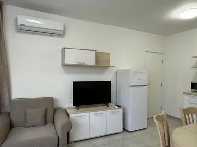 a living room with a television and a refrigerator at HORIZON Apartment 8,1 'A' Sveti Vlas in Sveti Vlas