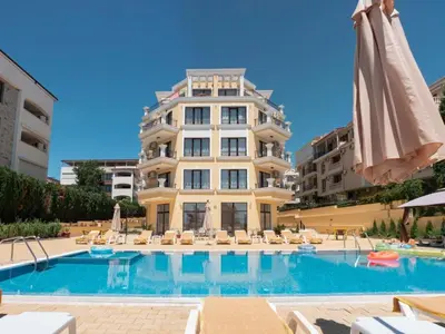 a hotel with a swimming pool in front of a building at HORIZON Apartment 8,1 'A' Sveti Vlas in Sveti Vlas