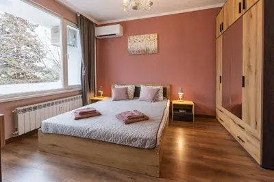 a bedroom with a bed and a window at Happy Lazur in Burgas City