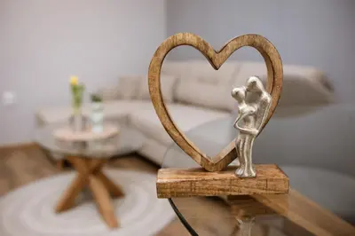 a statue of a person forming a heart on a table at Happy Lazur in Burgas City