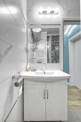 a bathroom with a white sink and a mirror at Perfect Seaside Retreat in Sveti Vlas Relax Complex by Flat Mаnаger in Sunny Beach