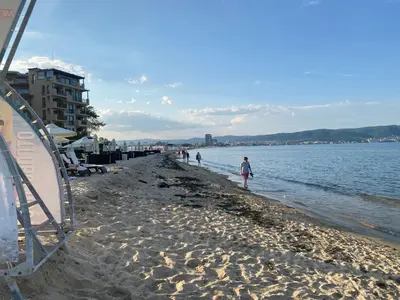 a group of people walking on the beach at AFRODITA II - 19 Studio Sunny Beach in Sunny Beach