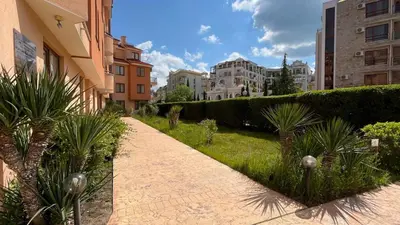 a walkway in a city with buildings and plants at KASANDRA 'Д' 5 Apartment Sunny Beach in Sunny Beach