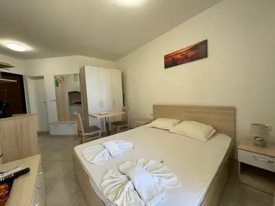 a bedroom with a bed with towels on it at HORIZON 7 'А' Studio Sveti Vlas in Sveti Vlas