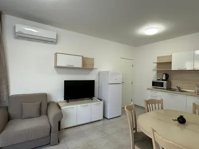 a living room with a refrigerator and a table at HORIZON 1 'A' APARTMENT Sveti Vlas in Sveti Vlas