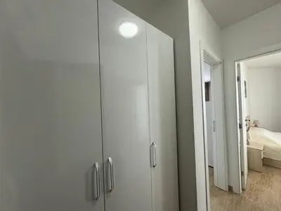 a white wardrobe in a room with a bedroom at HORIZON 12 'A' APARTMENT Sveti Vlas in Sveti Vlas
