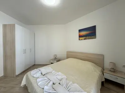 a bedroom with a bed with white sheets on it at HORIZON 13 'A' APARTMENT Sveti Vlas in Sveti Vlas