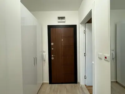 a hallway with a wooden door in a building at HORIZON 13 'A' APARTMENT Sveti Vlas in Sveti Vlas