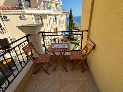 a balcony with two chairs and a table on a balcony at HORIZON 20 'A' APARTMENT Sveti Vlas in Sveti Vlas