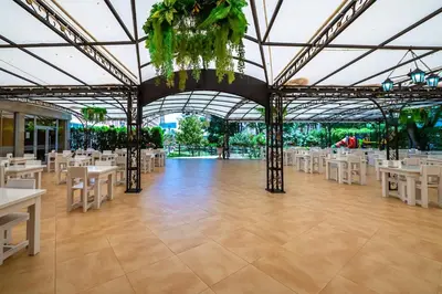 a large banquet hall with white tables and chairs at Hotel Riva - All Inclusive in Sunny Beach
