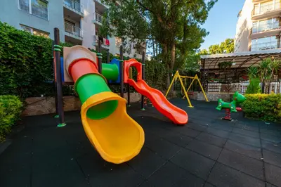 a playground with colorful slides and play equipment at Hotel Riva - All Inclusive in Sunny Beach